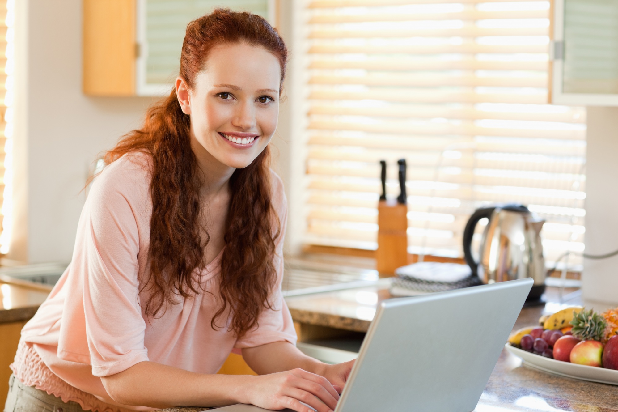 student smiling in a home kitchen