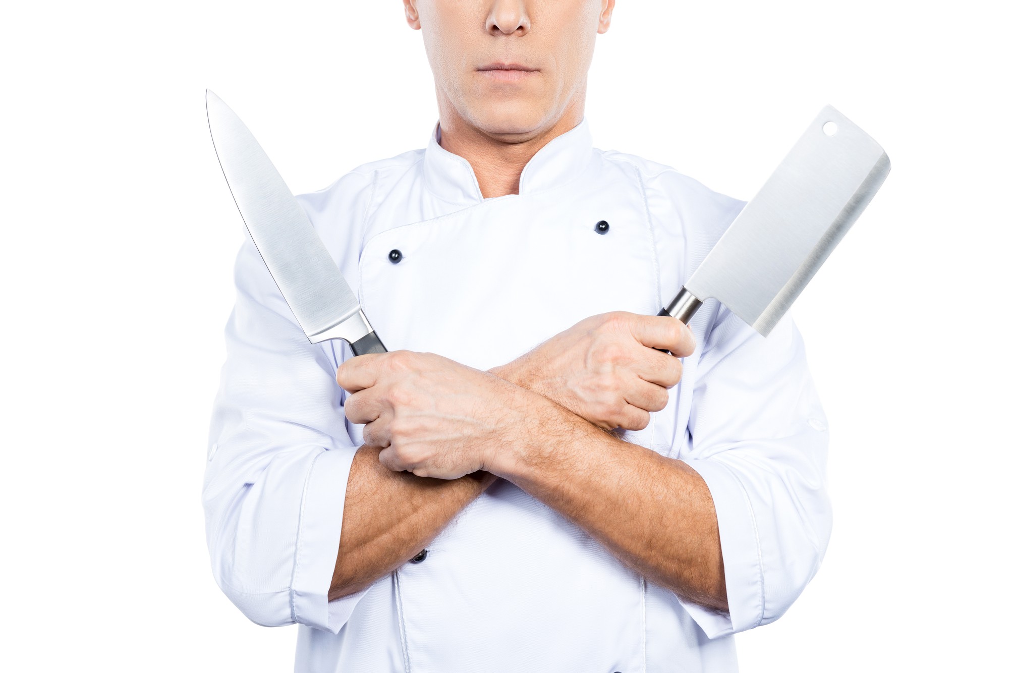 instructor demonstrating a knife technique in a bright kitchen