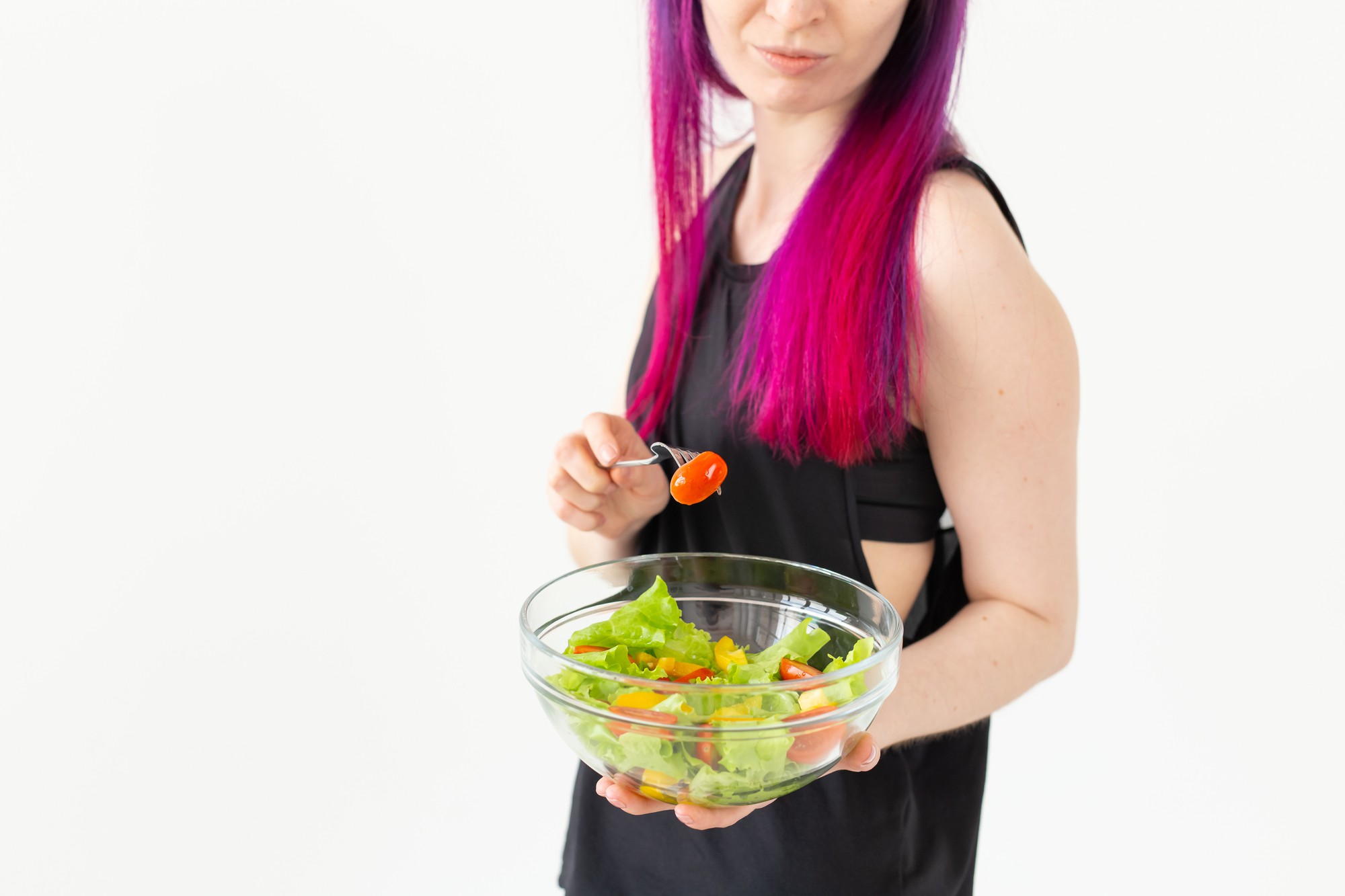 student plating a colorful salad